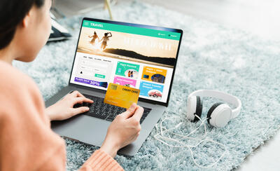 Girl lying on the carpet holding credit card